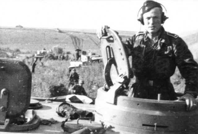 A soldier of the SS Division “Das Reich” in the turret of a Panzer Mk VI “Tiger” – By Bundesarchiv – CC BY-SA 3.0