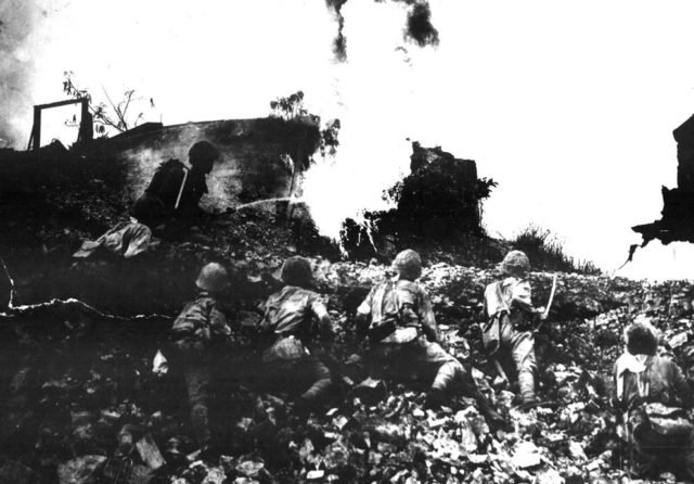 Japanese troops clearing an American position with a flamethrower, Corregidor, Philippine Islands, May 1942 [United States National Archives].