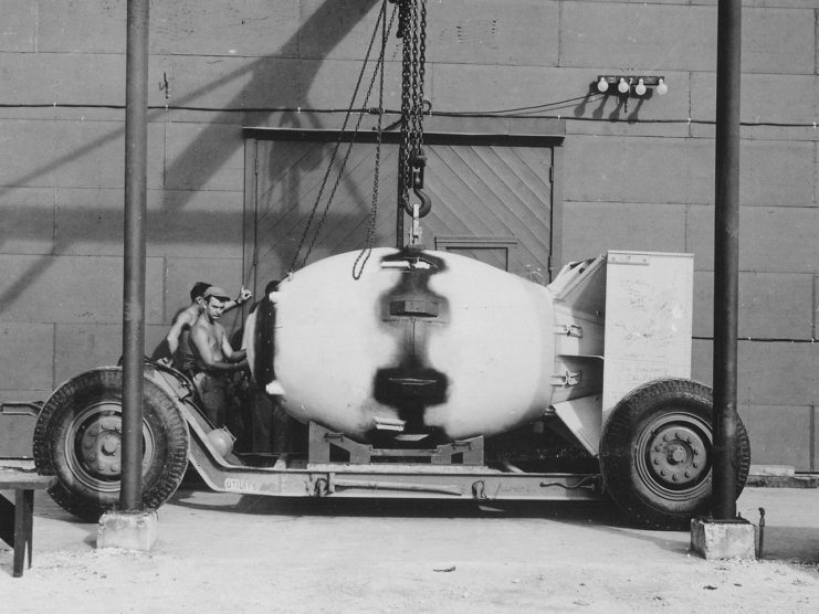 Fat Man unit being placed on trailer cradle in front of Assembly Building #2 on Tinian.