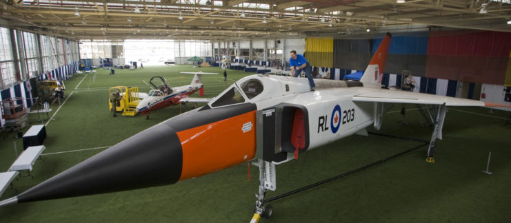 Ted McLellan, a volunteer at the Toronto Aerospace Museum, dusts off the Avro Arrow full scale replica in preparation for Toronto Wings & Wheels Heritage Festival