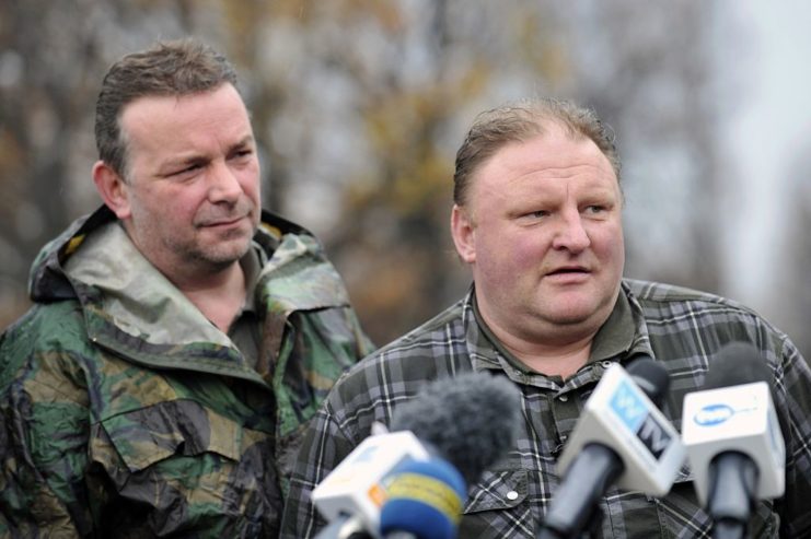 Andreas Ritcher and Piotr Koper standing in front of four microphones