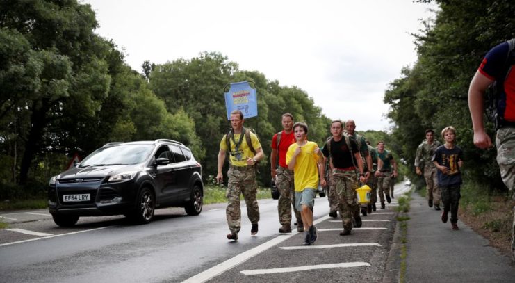 Chris Brannigan walking along a road with children