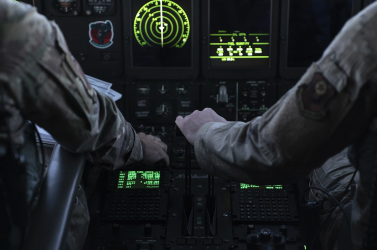 Two arms in front of an airplane cockpit