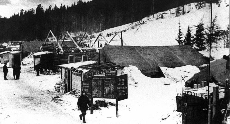 Male prisoner walking through a snow-covered camp area