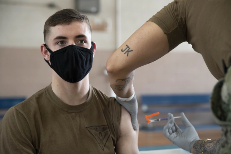 Male sailor being given the COVID-19 vaccine