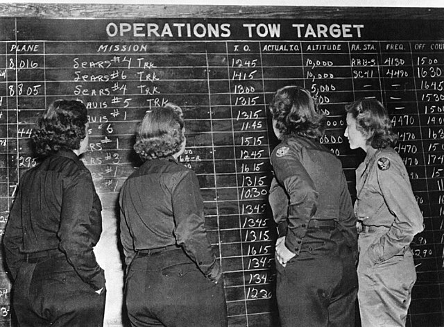 Four WASP members facing a blackboard