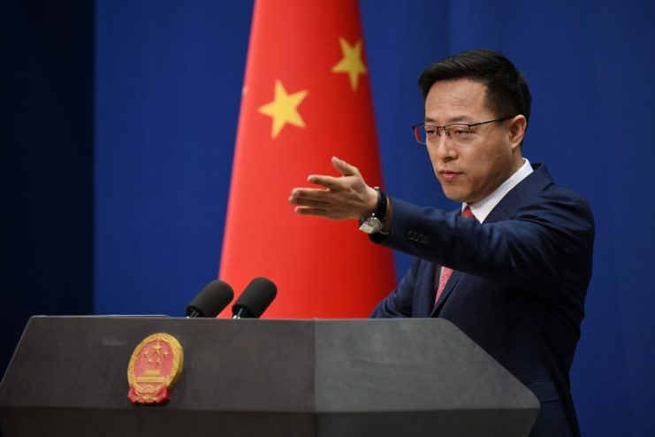 Zhao Lijian standing behind a podium