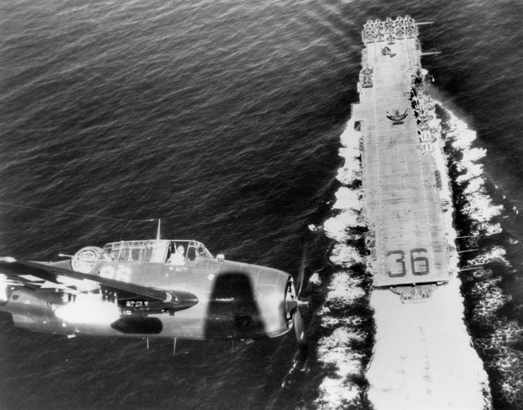 Grumman TBM-3E Avenger flying over the USS Antietam