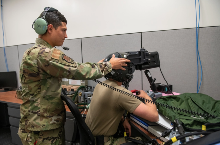 Staff Sgt. AJ Arteaga adjusts the head position of Tech. Sgt. Anthony Farnsworth