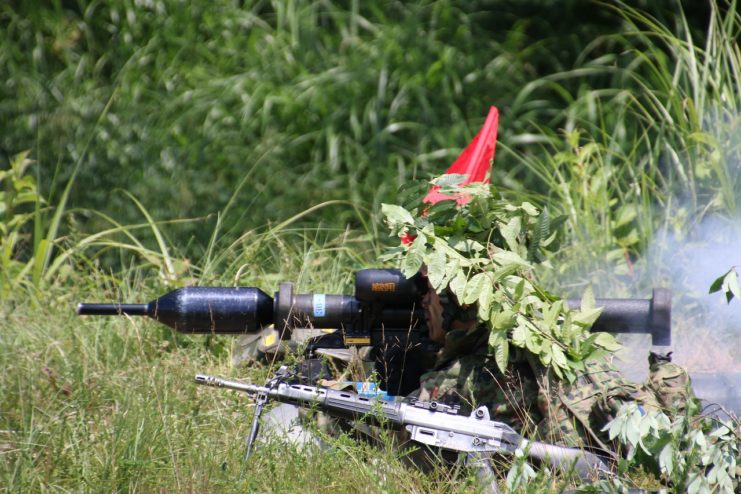 Japanese soldier camouflaged while holding a Panzerfaust 3