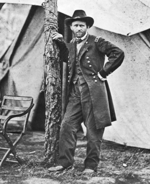 Ulysses S. Grant leaning against a tree at camp