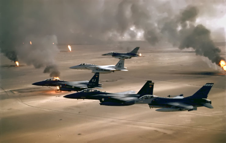 Five US Air Force aircraft flying over the Kuwaiti oil fires