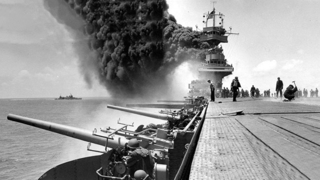 Another view of the Yorktown Courtesy of the Naval History and Heritage Command This view shows the giant plume of smoke coming from the USS Yorktown after it was attacked by Japanese planes during the Battle of Midway. The USS Astoria is shown in the left background.