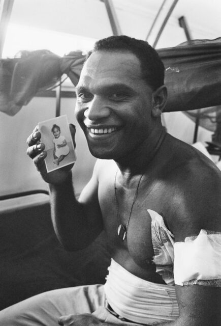 Cpl. Tom "Buddy" Lea holding up a picture of his daughter