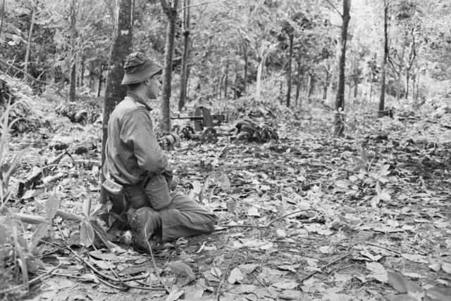 Second Lt. Dave Sabben kneeling in the middle of the Vietnamese jungle