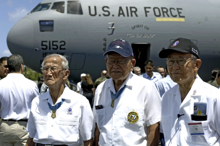 Barney Hajiro, Shizuya Hayashi and Ed Ichiyama standing near a Boeing C-17 Globemaster III