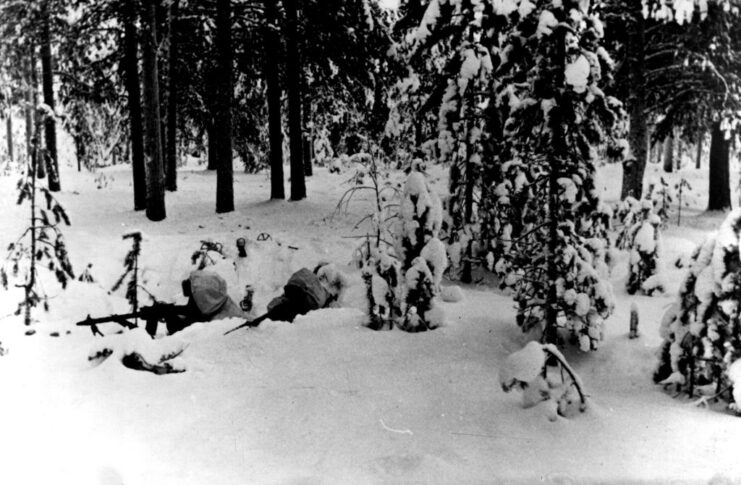 Two Finnish troops aiming their rifles in the snow