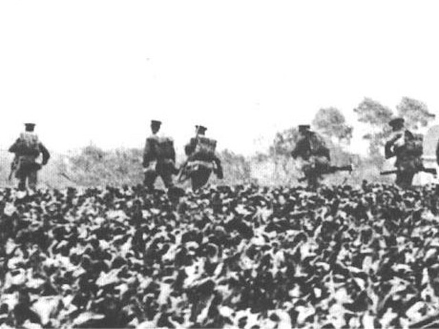 Soldiers walking through a field