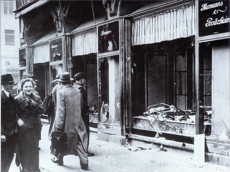 German civilians walking past a destroyed storefront