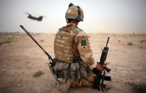 Member of the 3rd Battalion, Parachute Regiment kneeling in the sand