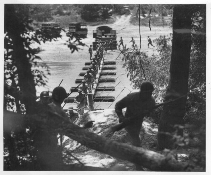 442nd Regimental Combat Team trainees running across a pontoon bridge