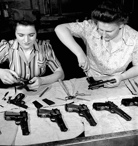 Two women assembling Browning Hi-Powers at a table