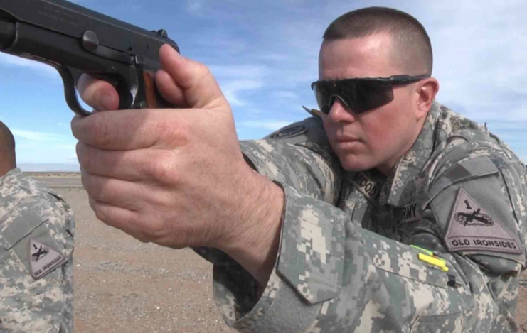 US Army soldier aiming a Browning Hi-Power