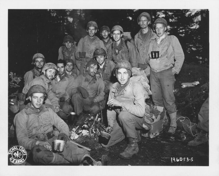 Members of the "Lost Battalion" standing together in a wooded area