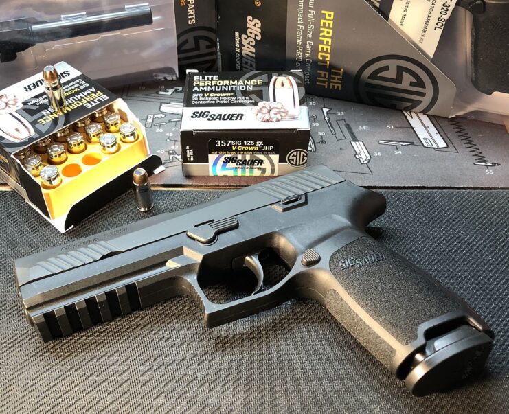 SIG Sauer P320 placed on a table with boxes of ammunition