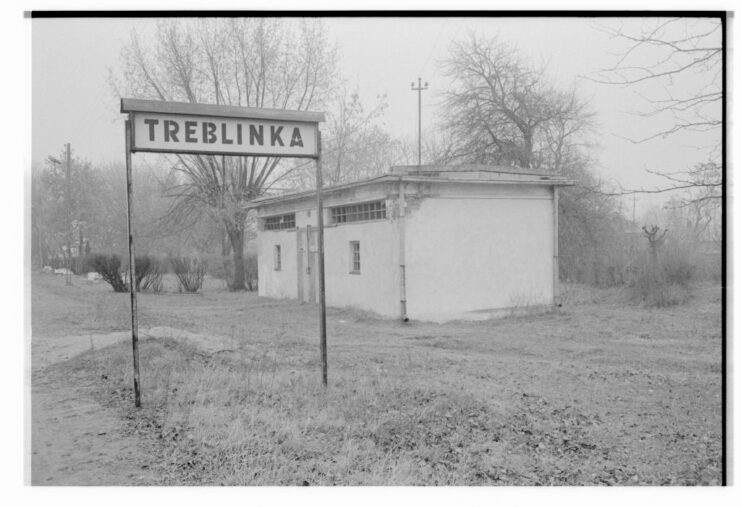 Railroad stop with an exterior sign that reads "TREBLINKA"