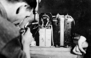 French Resistance member sitting in front of a radio