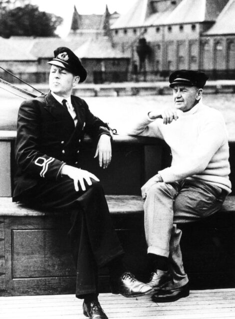 Charles Lightoller and his son, F.R. Lightoller, sitting together on a pier