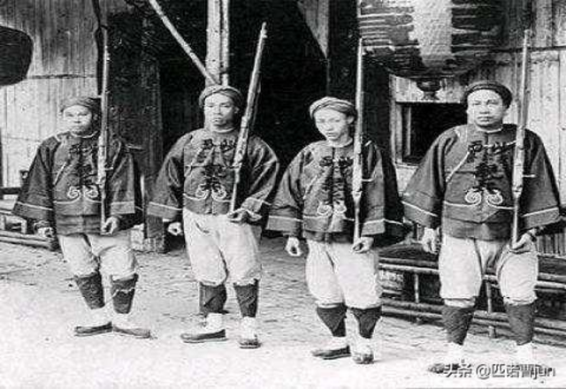 Four Chinese soldiers standing together, holding Dreyse needle-guns