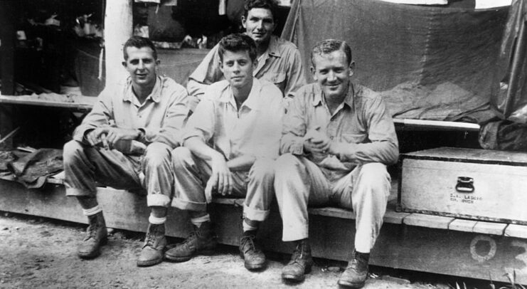 John F. Kennedy sitting with three other men