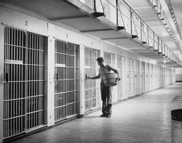 Janitor standing outside of a prison cell