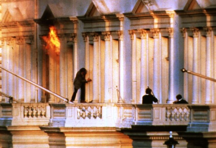 Individuals standing on the balcony of the Iranian Embassy in London, United Kingdom