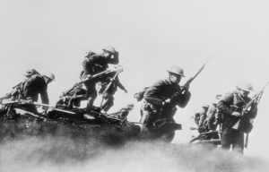 Canadian soldiers going over the top of a trench