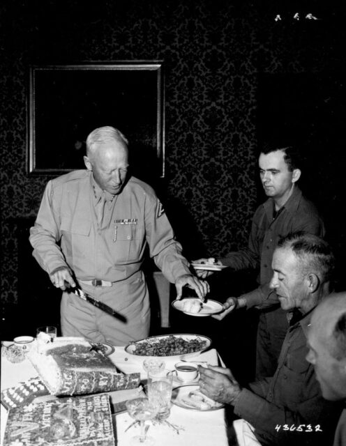 George Patton serving pieces of cake to guests