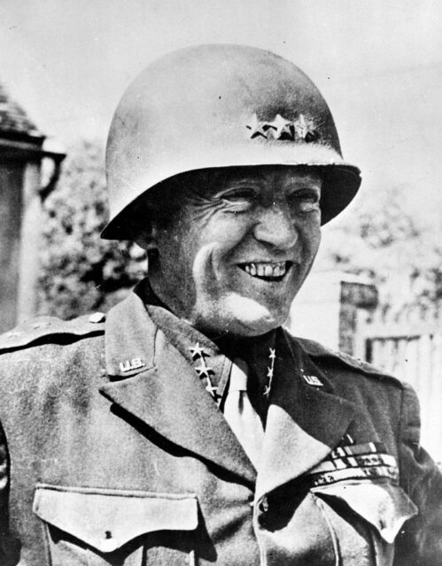 George Patton smiling while wearing his US Army uniform