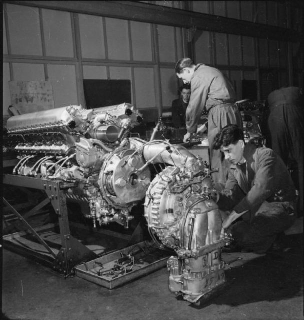 A factory worker makes the final adjustments to the Supercharger, which is now ready to be fitted to the engine at this factory, somewhere in Britain.