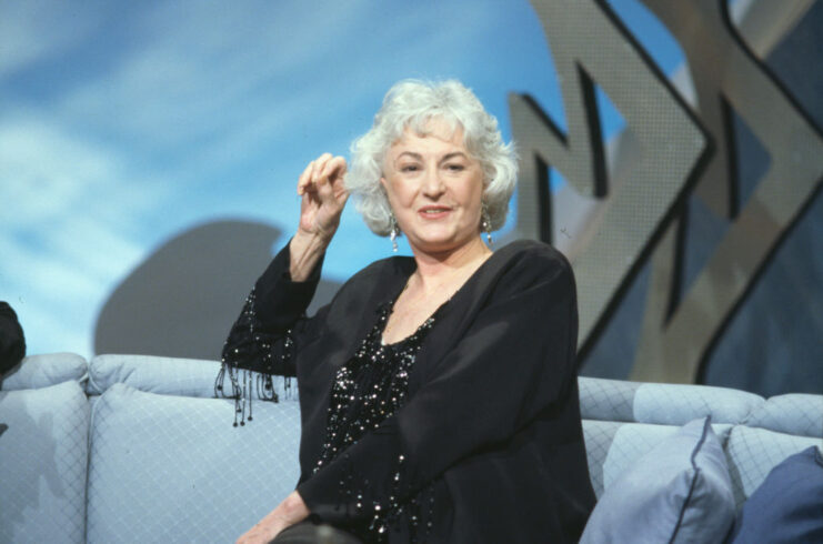 Bea Arthur sitting on a couch