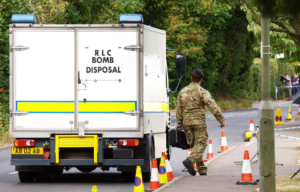 British soldier walking by a bomb disposal truck