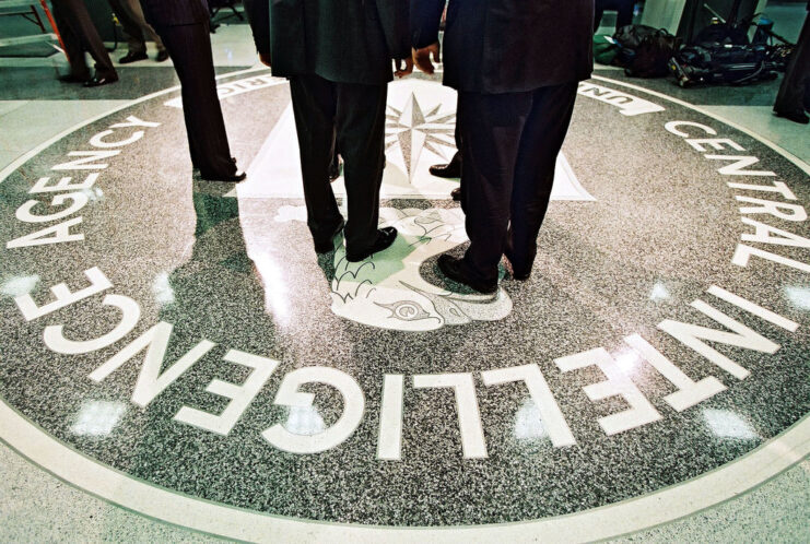 Men standing on the logo of the Central Intelligence Agency (CIA)