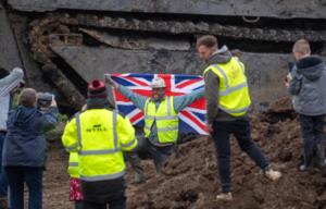 Daniel Abbott poses by a 26-foot-long Buffalo tank which has been extracted from the earth in Crowland, Lincolnshire, where it has been buried for 74 years since it was brought into the village to help during heavy floods in March 1947