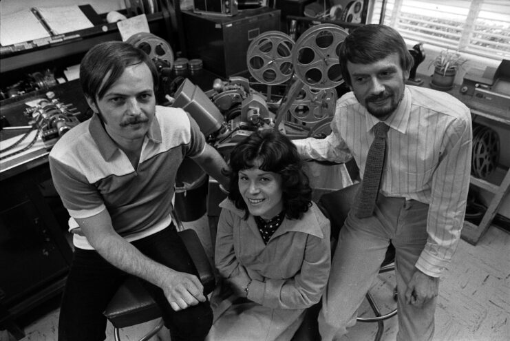 Günter Wetzel and Doris and Peter Strelzyk sitting in room filled with film equipment