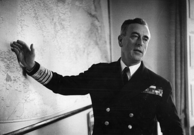 Lord Mountbatten gesturing toward a map on a wall