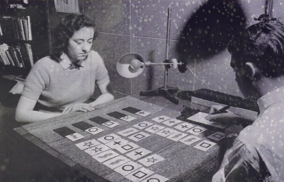 Woman sitting at a table where Zener cards have been laid out + Purple sparkles