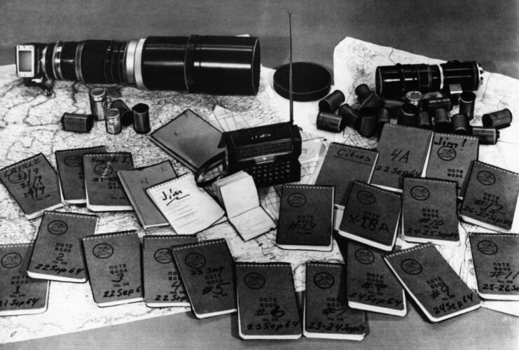 Books and other materials used for espionage purposes laid out on a table