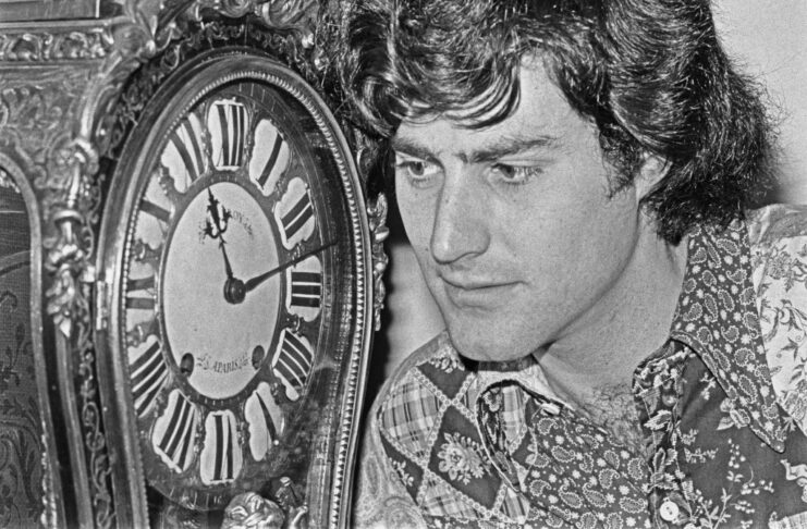 Uri Geller staring at a clock