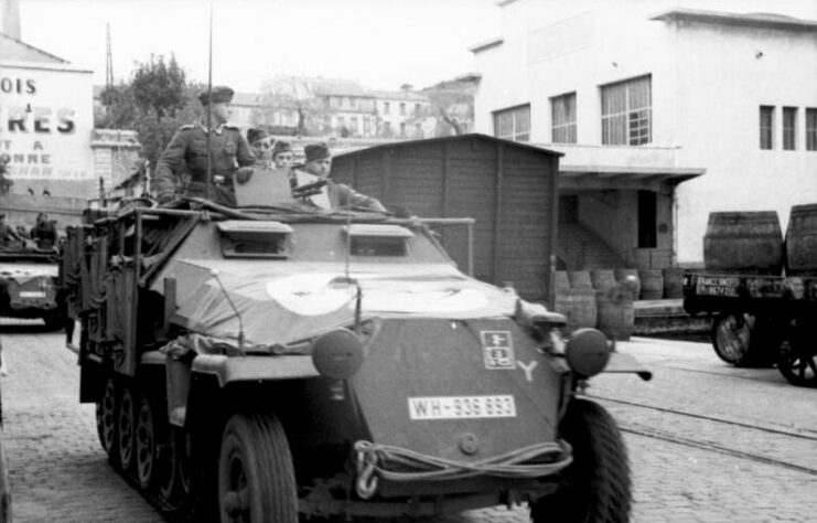 German soldiers manning an Sd.Kfz. 251 in the middle of a street